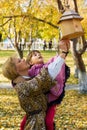 Mother and daughter with birdhouse in autumn park