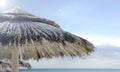 Looking at the blue sea through a straw beach umbrella.  On the background the sea. Selective focus, blurred background. Beach Royalty Free Stock Photo