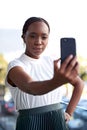 Looking cute and feeling fierce. a young businesswoman taking selfies with her smartphone. Royalty Free Stock Photo