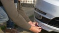 Looking at a damaged vehicle. man inspects car damage after an accident Royalty Free Stock Photo