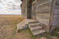 Looking at the door and steps of an abandoned farm house Royalty Free Stock Photo