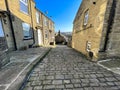 Backfield Street, with Victorian cobbled stones, and cottages in, Thornton, Yorkshire, UK Royalty Free Stock Photo