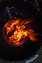 Looking down into the burning charcoal of a Chimney Starter on a backyard grill Royalty Free Stock Photo