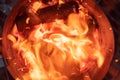 Looking down into the burning charcoal of a Chimney Starter on a backyard grill Royalty Free Stock Photo