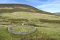 Looking down on circular sheepfold with small footbridge behind Royalty Free Stock Photo