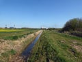 Looking down ditch to distant industry