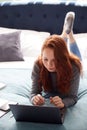 Looking Down On Female College Student Lying On Bed Working On Laptop And Using Mobile Phone Royalty Free Stock Photo
