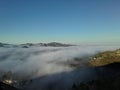 Looking down on Fog and Clouds Creeping along the Hills and Valley