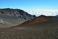 Looking down in the Haleakala Crater while clouds are being blown over the mountain ridge, Maui island, Hawaii Royalty Free Stock Photo