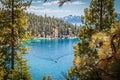 Looking Down Through Heavy Forest Onto Lake Tahoe USA And Mountains In Distance And Boat Creating Wake In Water Down Below