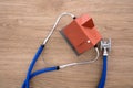 Looking down a house model with a stethoscope on the table Royalty Free Stock Photo