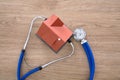 Looking down a house model with a stethoscope on the table Royalty Free Stock Photo