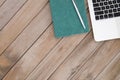 Looking down on laptop and notebook on wood background