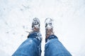 Leather boots covered in snow, legs with denim jeans Royalty Free Stock Photo