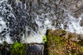 looking down an old stone bridge with rapid water flowing in the background Royalty Free Stock Photo