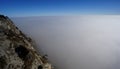 Looking down onto the clouds - Mountains above the clouds - Beautiful winter hiking day in Austria Royalty Free Stock Photo