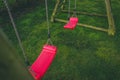 Looking down on a red abandoned swing in the garden