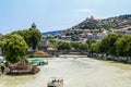 Looking down the river with boats and a party barge up to famous statue and cable car and buildings Royalty Free Stock Photo