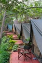 Looking down a row of canvas safari tents Royalty Free Stock Photo