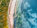 Shallow ocean water and rocky beach.