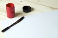 Sword pinstriping brush with red paint and paper Royalty Free Stock Photo