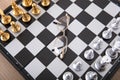 Looking down and shooting the facing chess pieces on the chessboard and a pair of glasses between the two sides Royalty Free Stock Photo