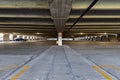 A concrete parking garage with yellow lines.