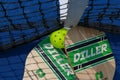 Looking down at two pickleball rackets at the tennis net with a whiffle ball Royalty Free Stock Photo