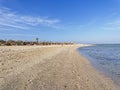 Down the long, wide beach at Marsa Alam under a blue sky