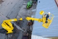 Looking down on woman in cherry picker Royalty Free Stock Photo