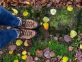 Looking down at woman`s feet in hiking boots on a rainy colorful