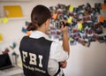 Looking for evidence. FBI woman works on a case. Using camera Looking for evidence