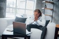 Looking at failure. Photo of young businessman sitting on coach and stressed out at work Royalty Free Stock Photo