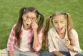 Looking fancy. Party girls wear prop glasses on green grass. Playful friends. Happy childhood. Fashion and beauty Royalty Free Stock Photo