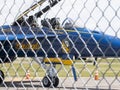 Looking through a fence at a U.S. Navy Blue Angels FA18 super hornet parked at an airport Royalty Free Stock Photo