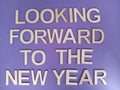 Looking forward to the new year sign on a purple background