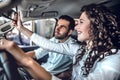 Looking forward to travel together. Happy young couple sitting in their brand new car smiling joyfully Royalty Free Stock Photo