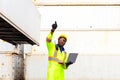 Looking forword. Foreman using laptop computer in the port of loading goods. Foreman showing thumbs up on Forklifts in the Royalty Free Stock Photo