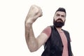 Looking frighteningly as a muscular man. Bearded muscular man shaking fist. Brutal hipster flexing his arm with muscular Royalty Free Stock Photo