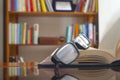 Looking glasses on an open book Royalty Free Stock Photo