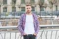 Looking good. student walk in city. handsome young man wear checkered shirt. casual dressed male fashion model posing Royalty Free Stock Photo