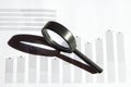 Looking at growth chart with magnifying glass. Graphs, charts and magnifying glass. Royalty Free Stock Photo