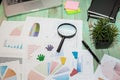 Looking at growth chart with magnifying glass. Graphs, charts and magnifying glass Royalty Free Stock Photo