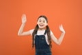 Looking happy and excited. Happy little girl with cute smile on orange background. Cheerful small child happy smiling Royalty Free Stock Photo