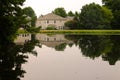 Looking at a housing development and green trees with a water reflection