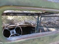 Looking Inside at the Steering Wheel in an Abandoned Old Car in the Desert Royalty Free Stock Photo
