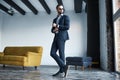 Looking just perfect. Full length portrait of young stylish businessman in suit who is standing in a modern office Royalty Free Stock Photo