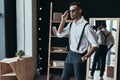 Looking just perfect. Handsome young man adjusting eyewear and k Royalty Free Stock Photo