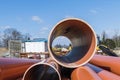 Looking through a large plastic pipe on a construction site