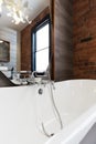 Looking into large white freestanding vintage bath tub